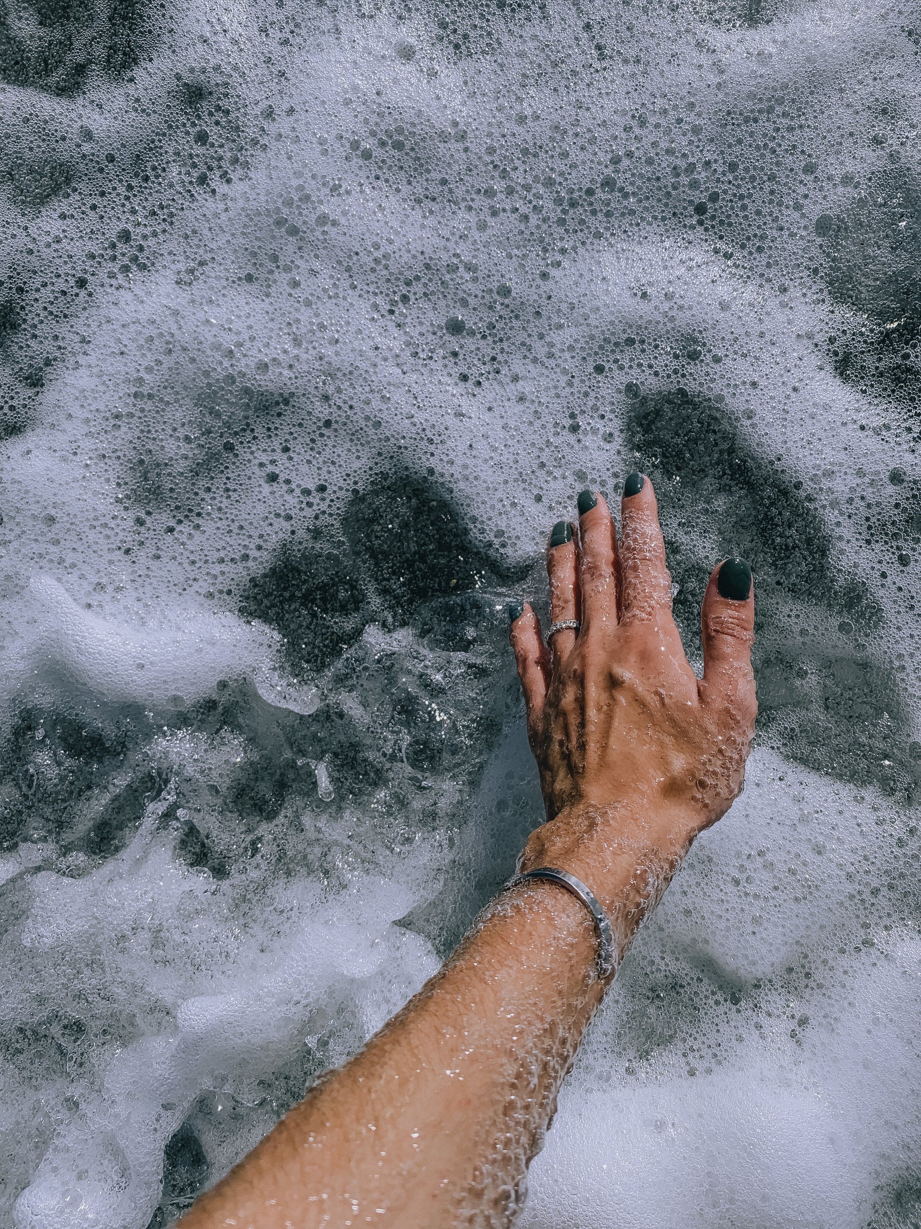 Person in Silver Bracelet on Water