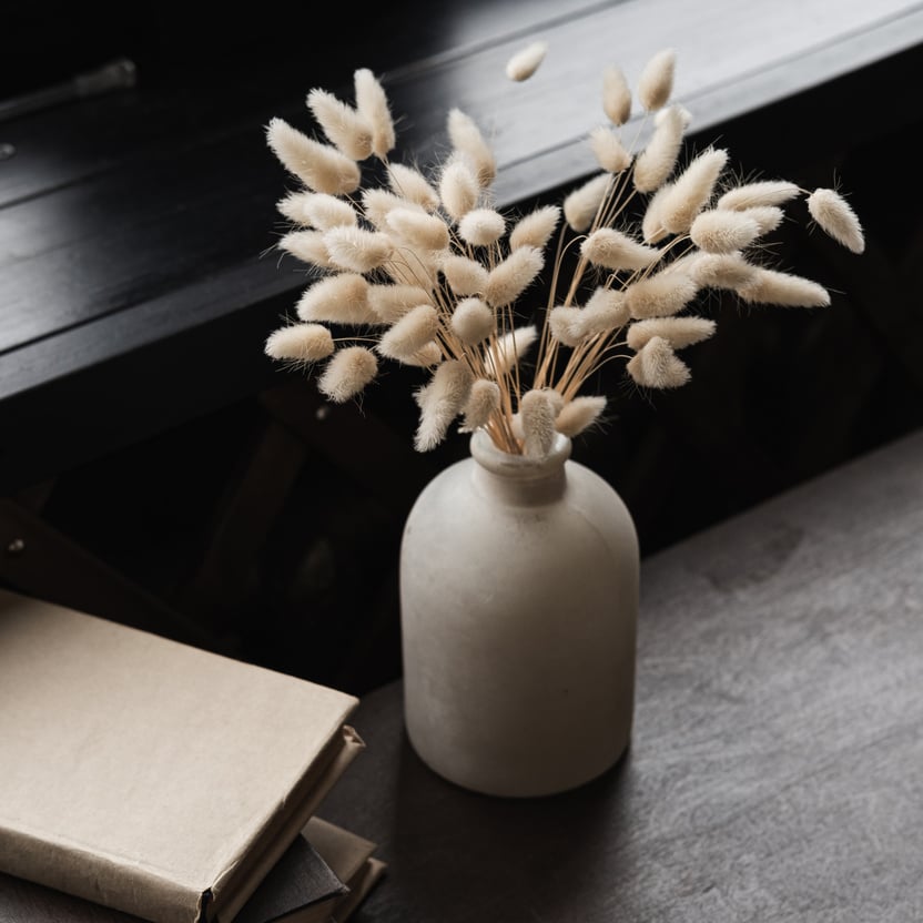 Books and Vase with Tail Grass on the Table